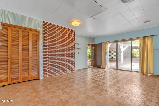 3054 Redbud Hwy, Honaker, VA 24260 - unfurnished living room with brick wall
