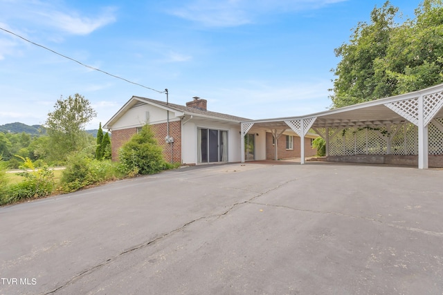 3054 Redbud Hwy, Honaker, VA 24260 - single story home featuring brick siding, a chimney, driveway, and a carport