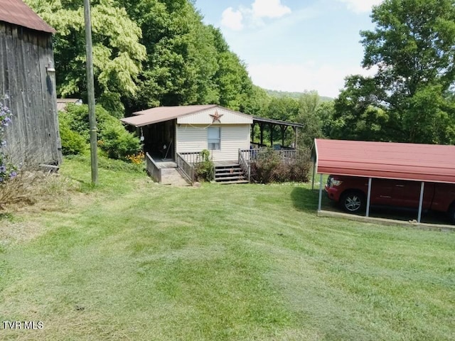 view of yard featuring an outbuilding and a carport