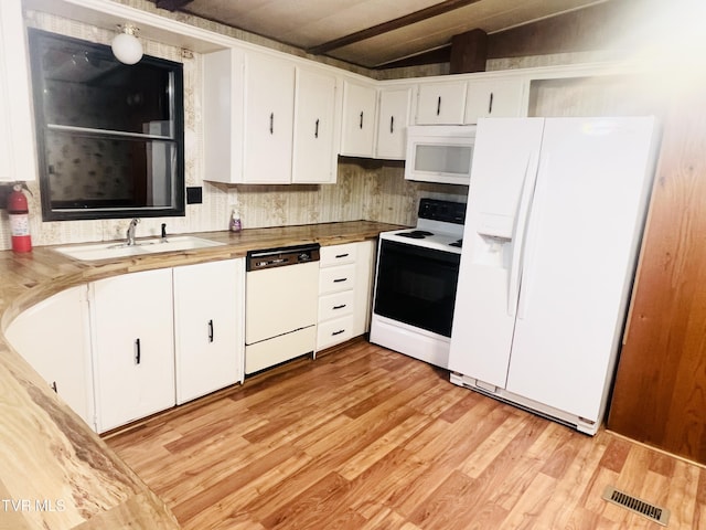 kitchen with white cabinets, vaulted ceiling with beams, white appliances, and sink