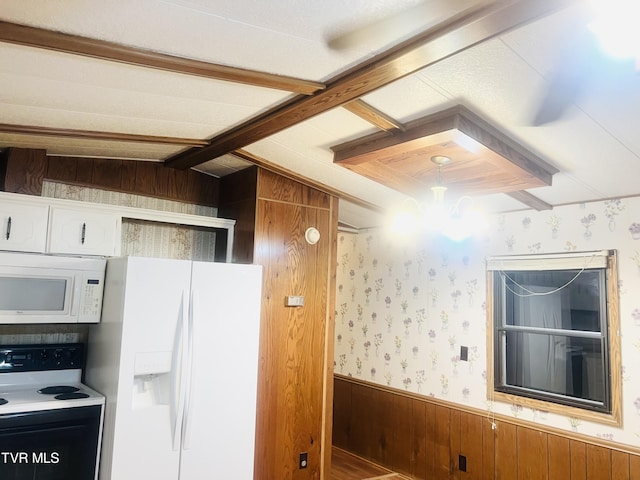 kitchen with white appliances, lofted ceiling with beams, wooden walls, and a notable chandelier