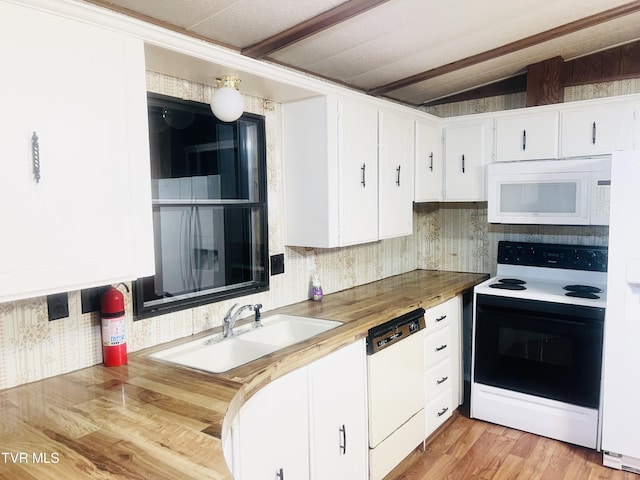 kitchen with sink, vaulted ceiling with beams, wooden counters, white appliances, and white cabinets