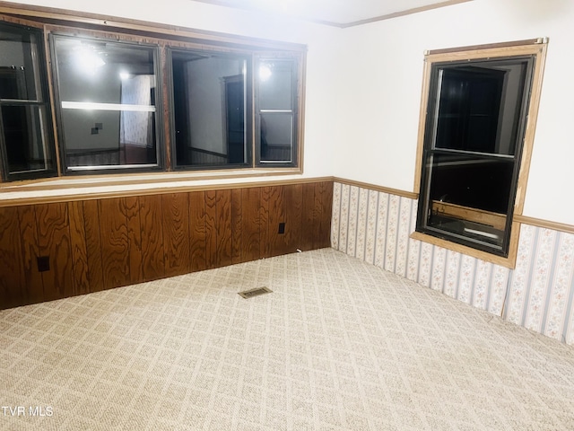 empty room with wood walls and carpet floors