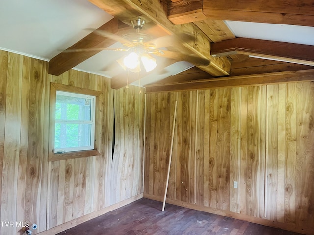 additional living space featuring wooden walls, dark hardwood / wood-style flooring, ceiling fan, and lofted ceiling with beams