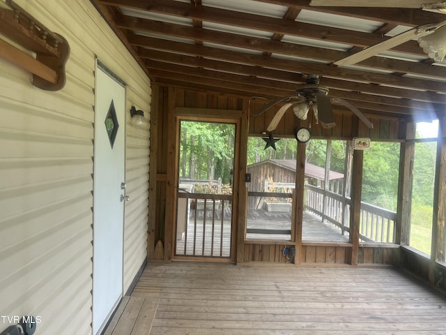 unfurnished sunroom featuring ceiling fan and lofted ceiling