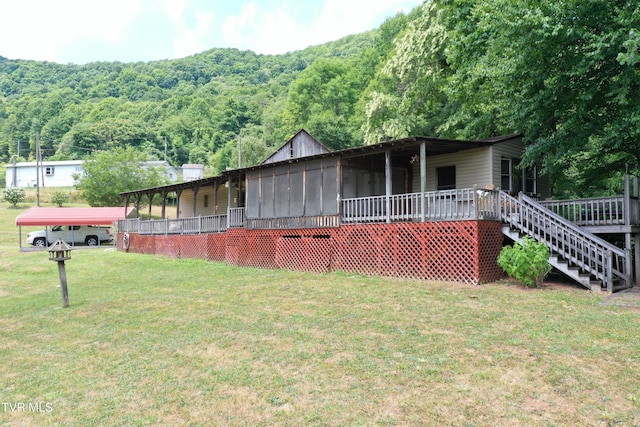 view of front facade with a sunroom and a front yard