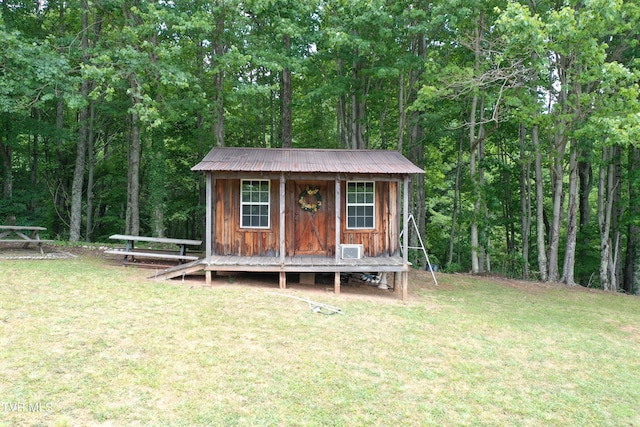 view of outbuilding featuring a lawn