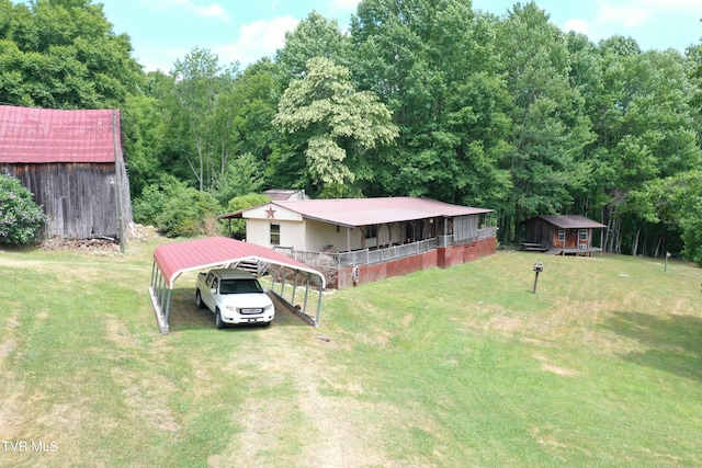 view of yard with an outbuilding and a carport