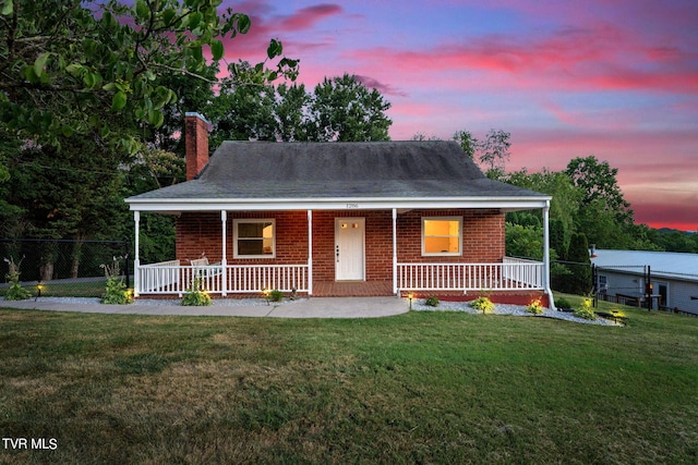 view of front of home with a lawn and covered porch