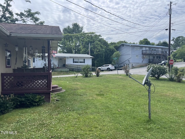 view of yard featuring covered porch