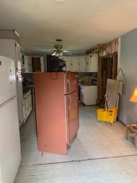 kitchen with stainless steel refrigerator, light tile patterned floors, white refrigerator, and ceiling fan