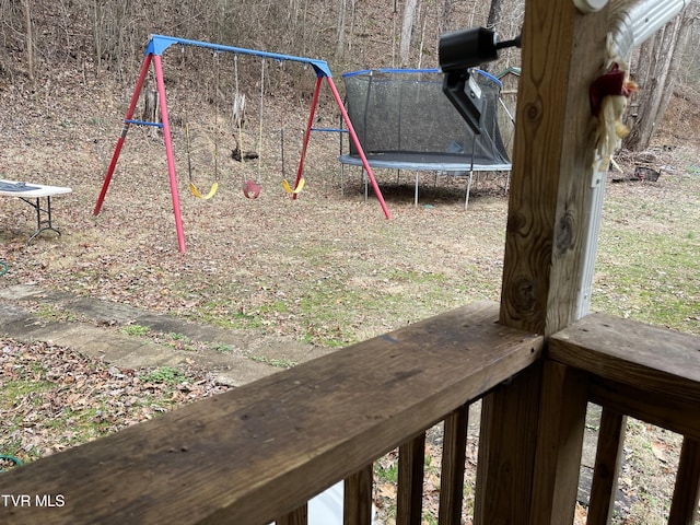 view of yard featuring a playground and a trampoline