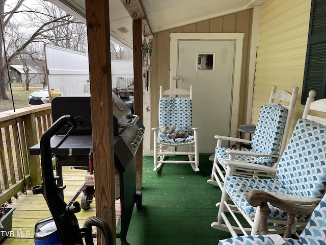 wooden deck featuring a grill