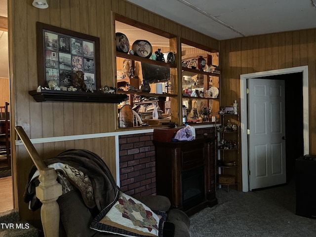 interior space featuring carpet flooring and wood walls