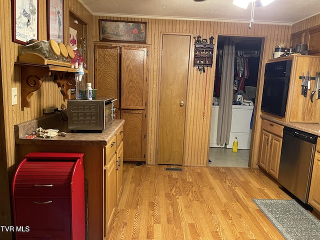 kitchen featuring washer / dryer, light hardwood / wood-style flooring, stainless steel dishwasher, and ornamental molding