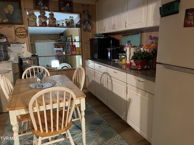 kitchen with dark hardwood / wood-style flooring, white cabinets, and white refrigerator