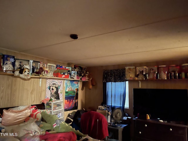 bedroom featuring wood walls