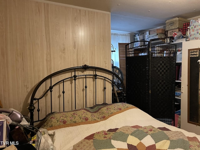 bedroom with wood walls