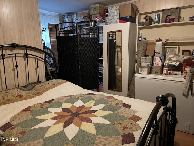 bedroom featuring wood walls