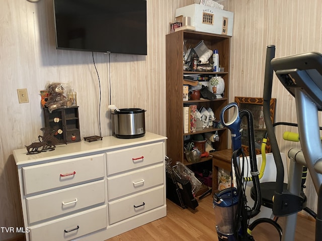 workout area with light hardwood / wood-style flooring