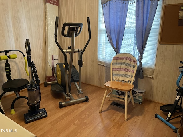 exercise room featuring hardwood / wood-style flooring and wood walls