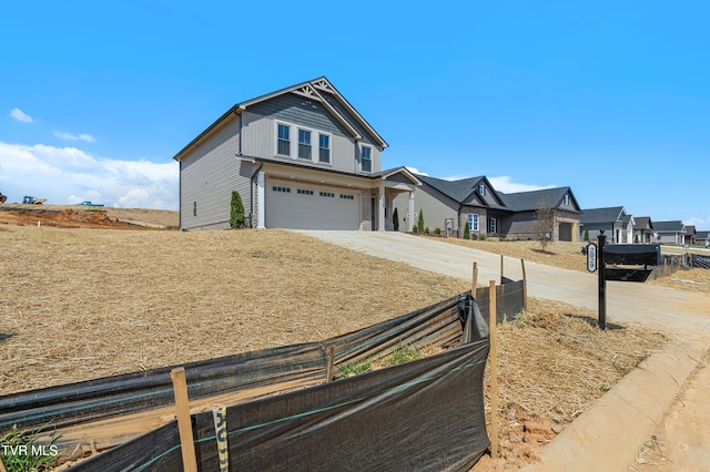 view of front of property with a garage, a residential view, fence, and concrete driveway