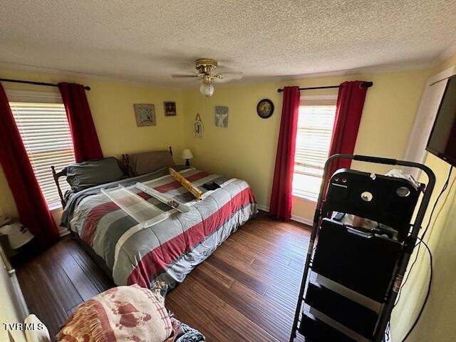 bedroom featuring ceiling fan, a textured ceiling, and hardwood / wood-style flooring