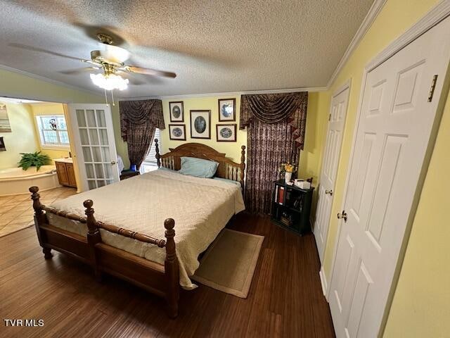 bedroom featuring ceiling fan, dark hardwood / wood-style flooring, ornamental molding, and a textured ceiling