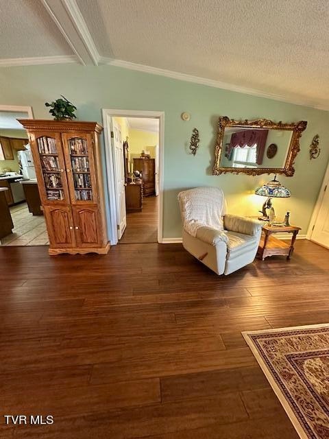 living room featuring lofted ceiling with beams, a textured ceiling, and hardwood / wood-style flooring