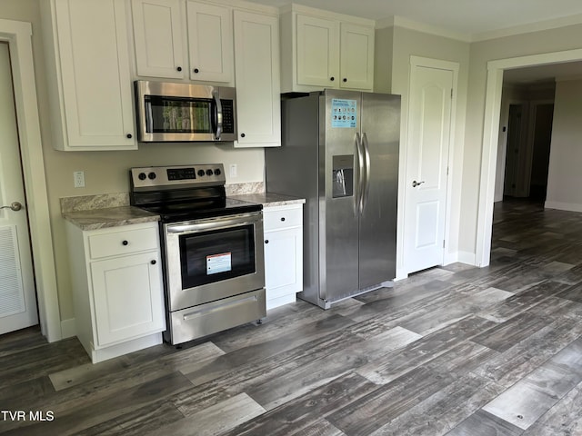 kitchen featuring white cabinets, crown molding, light stone countertops, appliances with stainless steel finishes, and dark wood-type flooring