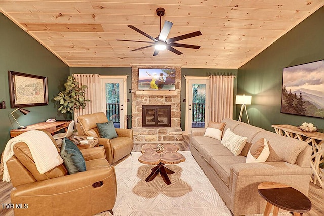 living room with ceiling fan, wooden ceiling, light hardwood / wood-style floors, vaulted ceiling, and a fireplace