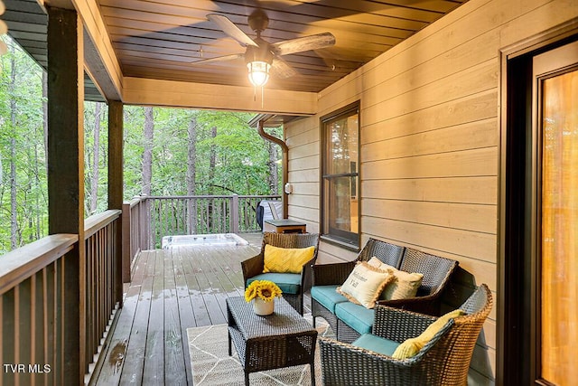 deck featuring ceiling fan and a jacuzzi