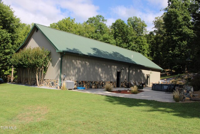 2044 Pigeon Creek Rd, Greeneville, TN 37743 - back of property featuring a yard, a patio, stone siding, and cooling unit