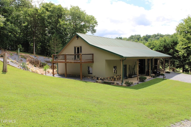 2044 Pigeon Creek Rd, Greeneville, TN 37743 - rear view of house with driveway, a deck, metal roof, and a yard