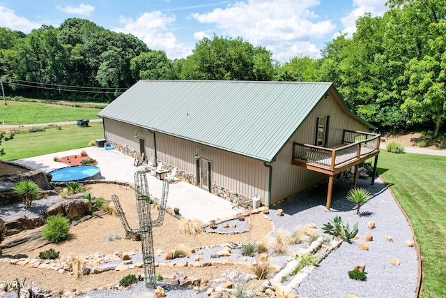 2044 Pigeon Creek Rd, Greeneville, TN 37743 - view of front of property featuring metal roof, an attached carport, stone siding, a wooden deck, and a front yard