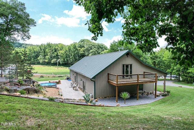 2044 Pigeon Creek Rd, Greeneville, TN 37743 - back of property featuring metal roof, a patio area, a deck, and a yard