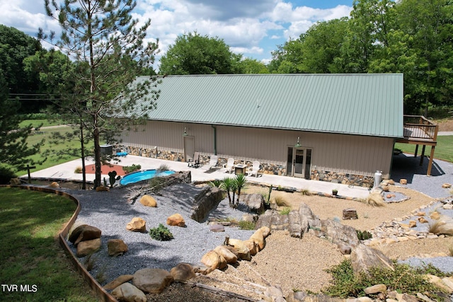 2044 Pigeon Creek Rd, Greeneville, TN 37743 - back of property featuring metal roof, stone siding, and a patio
