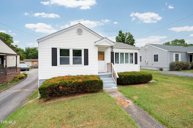 bungalow-style house with a front lawn