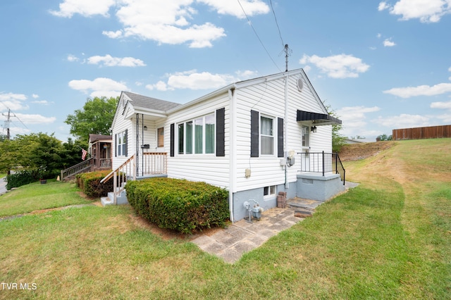 view of side of property with a lawn