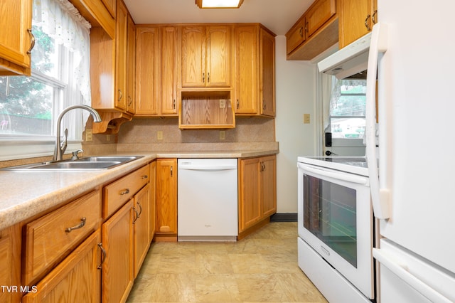 kitchen featuring white appliances, light tile patterned floors, tasteful backsplash, extractor fan, and sink