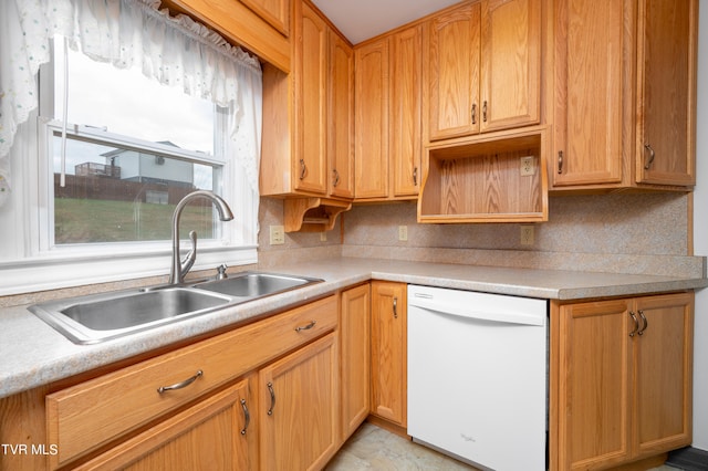 kitchen featuring light tile patterned floors, white dishwasher, tasteful backsplash, and sink