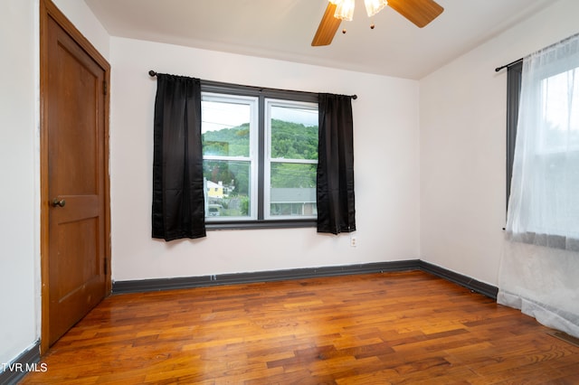 unfurnished room with ceiling fan and hardwood / wood-style floors