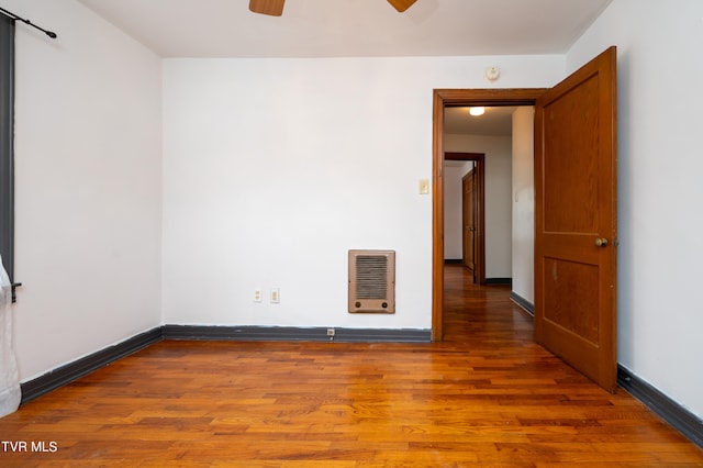 empty room with wood-type flooring and ceiling fan