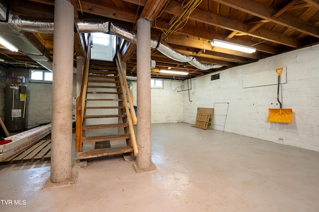 basement featuring electric water heater and a wealth of natural light