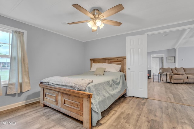 bedroom featuring ornamental molding, baseboards, and light wood-type flooring