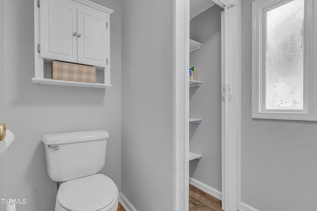 bathroom featuring hardwood / wood-style floors and toilet