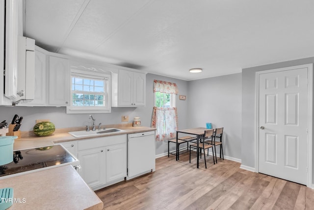 kitchen with white cabinets, dishwasher, light hardwood / wood-style floors, and sink