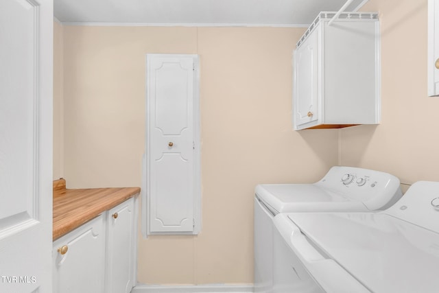 laundry area featuring cabinets and washing machine and clothes dryer