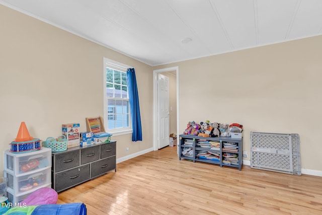 rec room with light hardwood / wood-style flooring