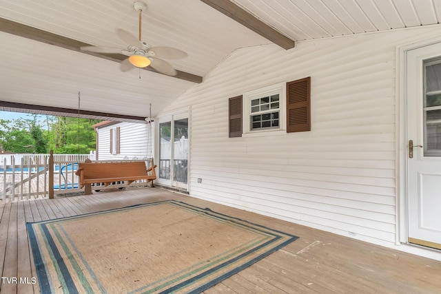 deck featuring a fenced in pool and ceiling fan